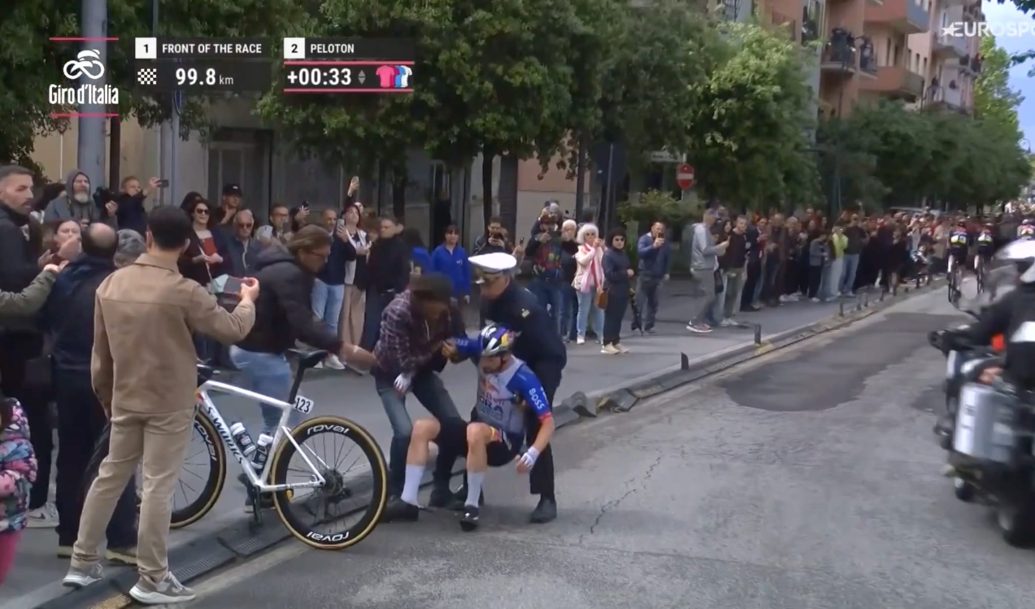 Supporter and officer picking him up.